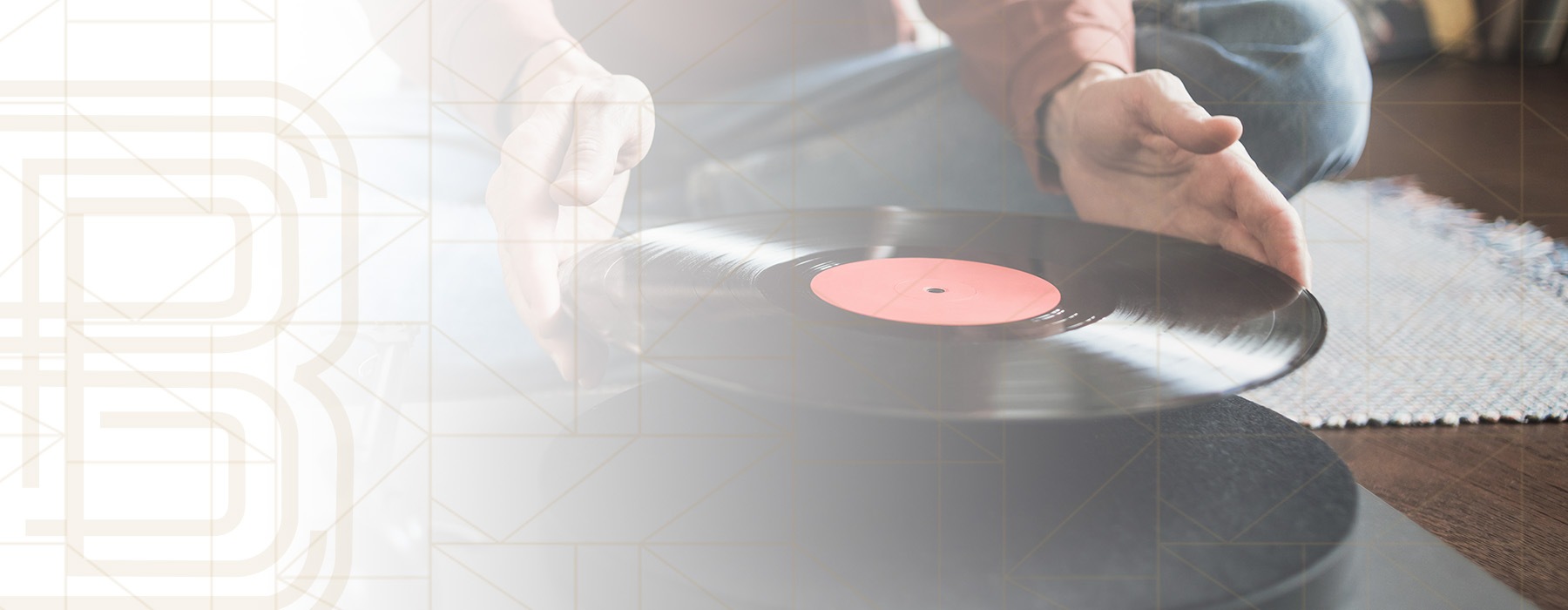 edited image of someone placing a vinyl record onto a record player